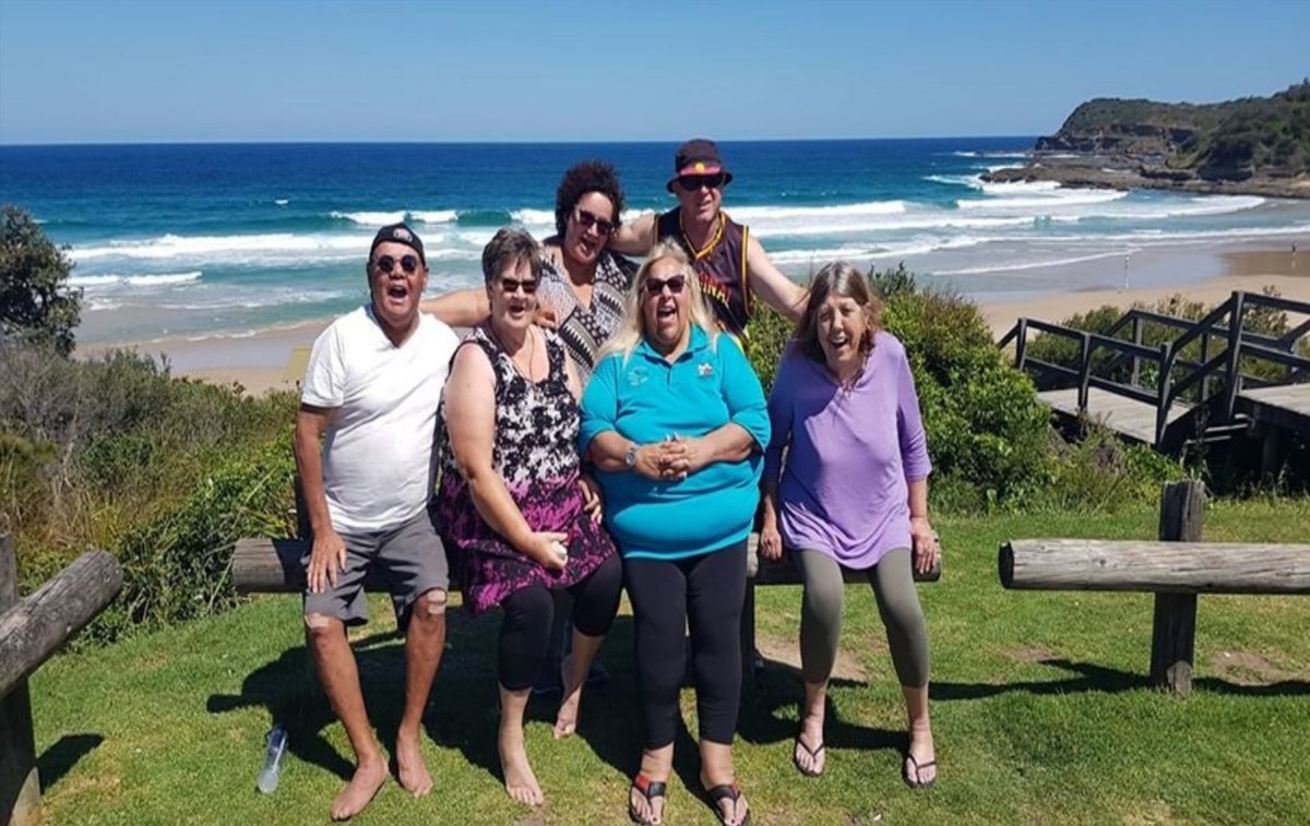 Wolkara members laughing together by the ocean during a retreat.